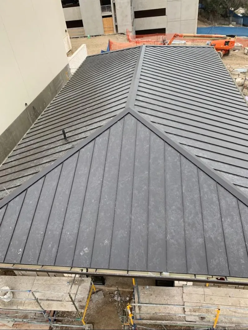 Commercial metal roof construction with crane equipment in Grosse Ile