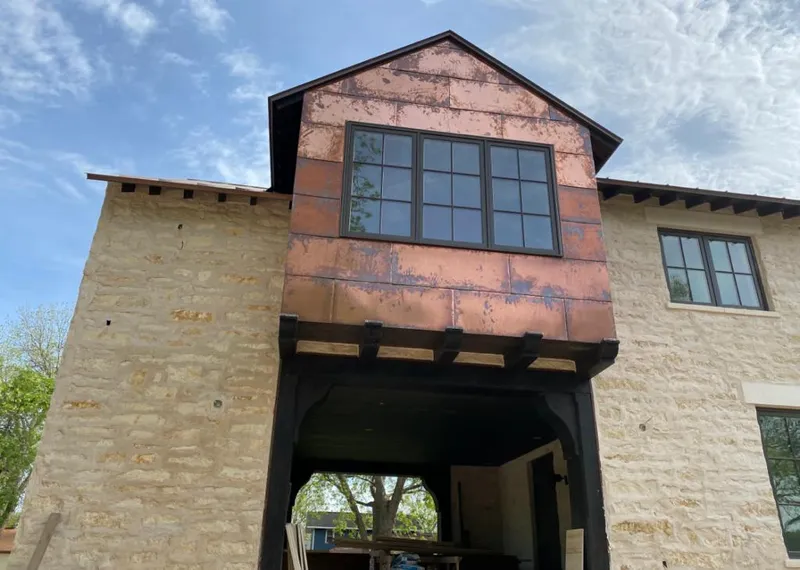 Copper metal panel facade on a stone building for Roof Repair in Grosse Ile