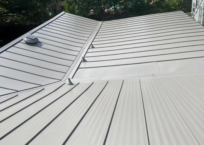 Solar attic fan installed on a metal roof for Roof Ventilation in Grosse Ile